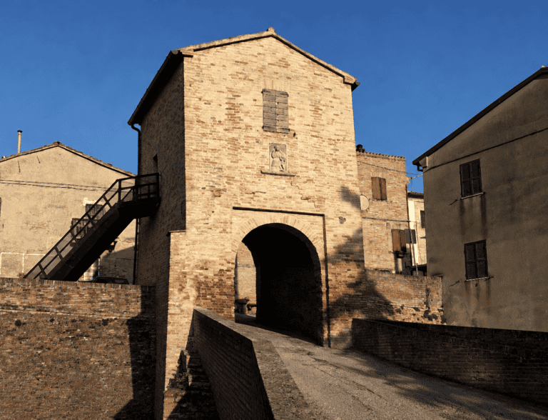 Ingresso medievale del castello di Montefabbri con lo stemma dei conti Paciotti, borgo dei sogni delle Marche